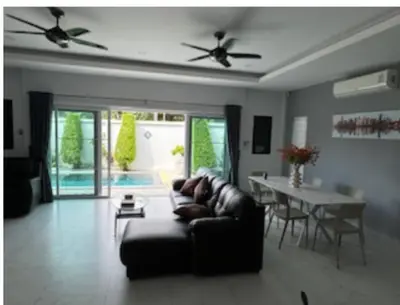 a living room with a couch and a table at Luxury 4 Bedroom Beach House in Ban Saiyuan (1)