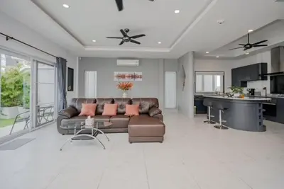 a large living room with a couch and a table at Luxury 4 Bedroom Beach House in Ban Saiyuan (1)