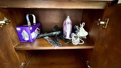 a shelf with a purple box and other items on it at Onyx Pool Villa in Phuket Town