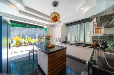 a kitchen with white cabinets and a large window at \u542b\u65e9\u9910\u9001\u63a5\u673a Phuket patong 4Bedrooms seaview Pool villa in Patong Beach