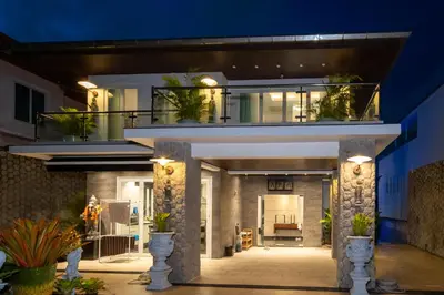 a house with a balcony with potted plants on it at \u542b\u65e9\u9910\u9001\u63a5\u673a Phuket patong 4Bedrooms seaview Pool villa in Patong Beach