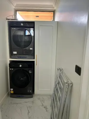 a room with a microwave and a washer and dryer at Gold Chariot 4BR villa with pool in Phuket