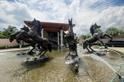 a statue of horses playing in a fountain at Gold Chariot 4BR villa with pool in Phuket