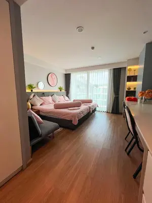two beds in a large room with a kitchen at Private apartments near Kata beach in Kata Beach