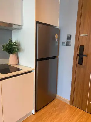 a kitchen with a stainless steel refrigerator next to a door at Private apartments near Kata beach in Kata Beach