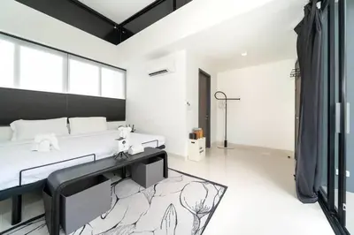 a white room with a bed and a tv at \u9038\u6d77\u306e\u5922 Laguna\u4e09\u5367\u5ba4\u79c1\u4eba\u6cf3\u6c60\u522b\u5885 in Ban Phru Champa