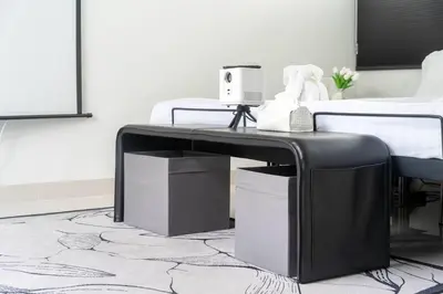 a black table in front of a bed at \u9038\u6d77\u306e\u5922 Laguna\u4e09\u5367\u5ba4\u79c1\u4eba\u6cf3\u6c60\u522b\u5885 in Ban Phru Champa