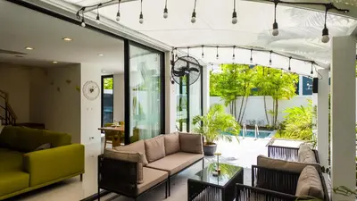a living room with two couches and a table at Laguna Park 2 Family Pool Villa near Bang Tao Beach in Bang Tao Beach