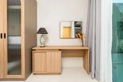 a dressing table with a mirror and a lamp on it at Villa Plunge Modern 2-Bedroom with Private Pool in Rawai Beach