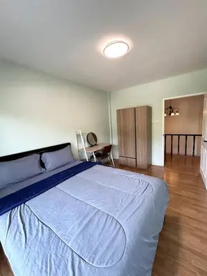 a bedroom with a large bed with a blue blanket at Villa Patong Beach in Patong Beach