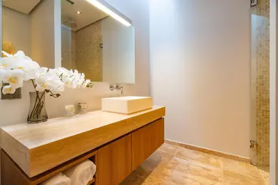 a bathroom with a sink and a mirror at Modern 3BR Pool Villa at Anchan Flora in Bangtao in Bang Tao Beach