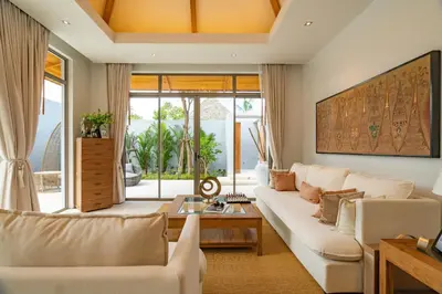 a living room with a couch and a table at Modern 3BR Pool Villa at Anchan Flora in Bangtao in Bang Tao Beach