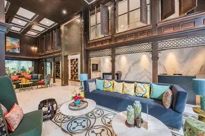 a living room with a blue couch and a table at The Base Central Phuket in Phuket Town