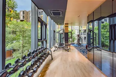 an empty gym with benches and large windows at The Base Central Phuket in Phuket Town