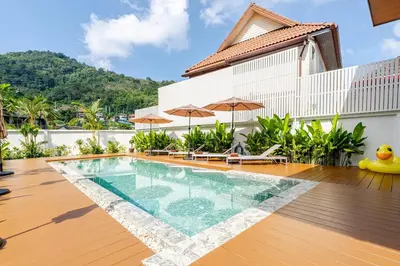 a swimming pool in the middle of a house at Oasis by the Sea M1- House with Pool and Amenities in Phuket Town