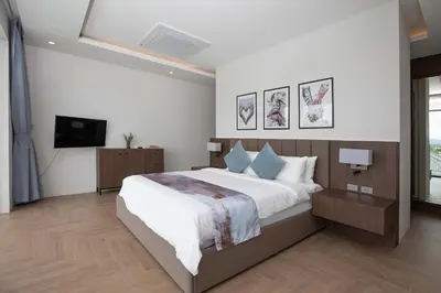 a bedroom with a large bed and a television at Ultra-Modern Tropical Pool Villa in Phuket