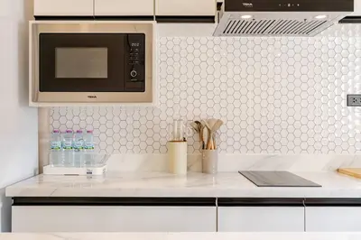 a kitchen with a white counter top with a microwave at Oasis by the Sea M2- House with Pool and Amenities in Phuket Town