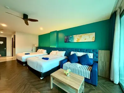 a hotel room with two beds and a couch at Deluxe Twin Bed Apartment by Renttini in Kamala Beach
