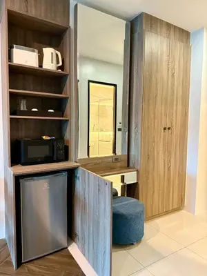 a room with a kitchen with a microwave and a cabinet at Deluxe Twin Bed Apartment by Renttini in Kamala Beach