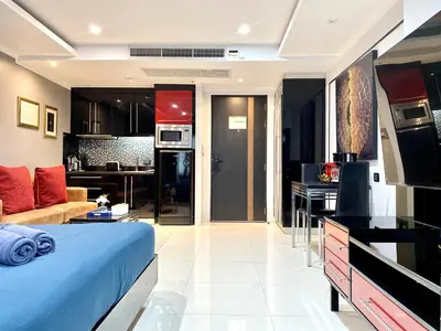 a room with a bed and a kitchen and a living room at Patong - Studio Condo - Absolute Bangla Unit in Patong Beach