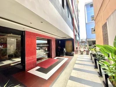 a building with a red brick wall and a red rug at Patong - Studio Condo - Absolute Bangla Unit in Patong Beach