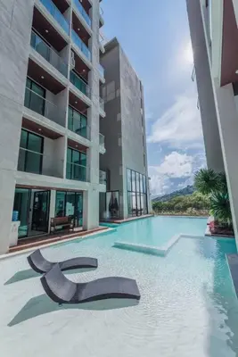 a swimming pool in front of a building at Sunset Mountain View 2bedroom Patong in Patong Beach