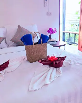 a bed with two baskets on top of it at Bung Bud Garden Bungalows & Homestay - Koh Yao Noi in Phangnga