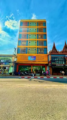 a tall orange building on the side of a street at KS Residence Patong in Patong Beach