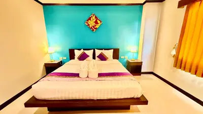 a bedroom with a bed with two shoes on it at KS Residence Patong in Patong Beach
