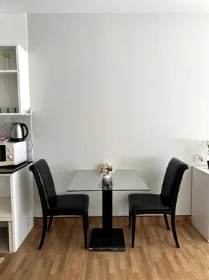 a table with two chairs and a vase with flowers at Сhic condo студия с бассейном in Karon Beach