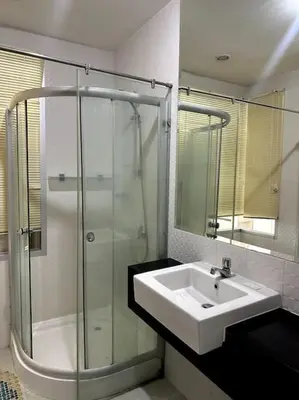 a bathroom with a sink and a glass shower at Сhic condo студия с бассейном in Karon Beach