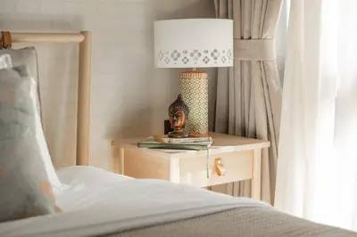 a lamp sitting on a table next to a bed at Title Halo Wild Spirit Naiyang Pool Gym 2BR in Nai Yang Beach