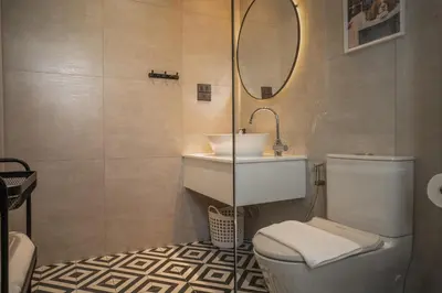 a bathroom with a toilet and a sink and a mirror at Title Halo Wild Spirit Naiyang Pool Gym 2BR in Nai Yang Beach