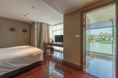 a hotel room with a bed and a large window at Angsana Laguna Phuket, family suite villa duplex, private unit with hotel kids club, pools and beach access in Laguna Phuket