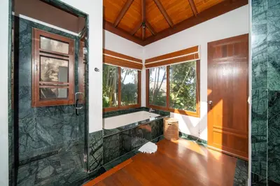 a bathroom with a shower and a large window at surin Luxurious 6br private swimming pool stunning sunset in Phuket Town