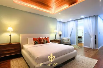 a bedroom with a large bed with a wooden ceiling at Golden Lily 4 Bedroom Private Pool Villa in Rawai Beach