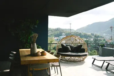 a balcony with a couch and a table and chairs at 600m to beach New City gate P214 #c60 in Kamala Beach