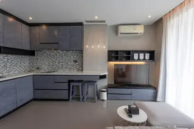 a kitchen with gray cabinets and a table in it at 600m to beach New City gate P214 #c60 in Kamala Beach