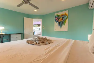 a bed in a room with a ceiling fan at 4 Big Separate Apartments SeaView 8KingBeds v104 in Karon Beach
