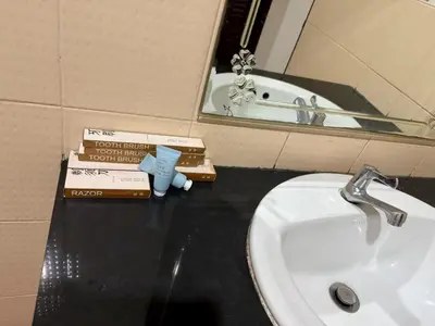 a bathroom with a sink and some books on a counter at sun flower \u4e00\u5367\u7cbe\u54c1\u5927\u5e8a\u623f in Patong Beach
