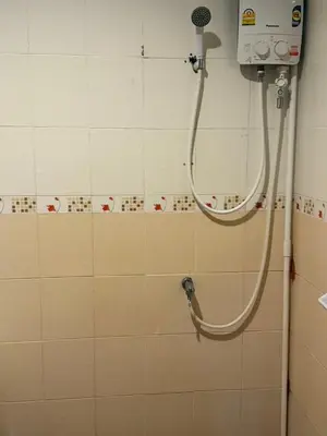 a shower in a bathroom with a hose on a wall at sun flower \u4e00\u5367\u7cbe\u54c1\u5927\u5e8a\u623f in Patong Beach