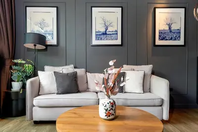 a living room with a couch and a table at Saturdays by Lotus Heart in Ban Saiyuan (1)