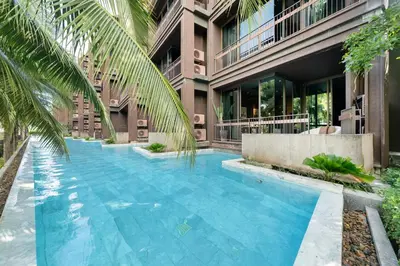 a swimming pool in front of a building at Saturdays by Lotus Heart in Ban Saiyuan (1)