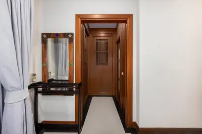 a hallway with a wooden door and a mirror at Meraya Villa with Private Pool Near Nai Harn Beach in Rawai Beach