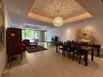 a dining room and living room with a table and chairs at A lovely 2-3 bed only 300m walk to Bangtao Beach in Phuket