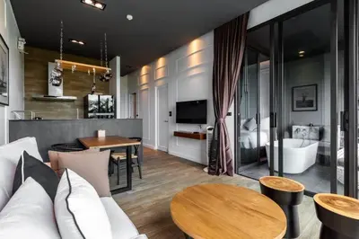 a living room with a couch and a table at Saturdays Residence 1 bedroom Rawai in Ban Saiyuan (1)