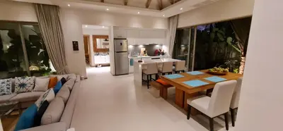 a kitchen and living room with a table and chairs at Luxury 3 bedroom pool villa in Laguna Phuket