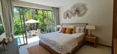 a bedroom with a bed and a large window at Luxury 3 bedroom pool villa in Laguna Phuket