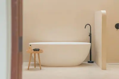 a white bath tub in a bathroom with a table at Villa Cabana in Ban Saiyuan (1)