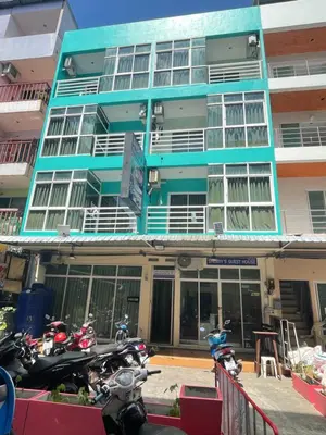 a blue building with motorcycles parked in front of it at SHERRY'S Guest House in Patong Beach